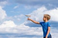 Boy throwing paper plane against blue sky Royalty Free Stock Photo