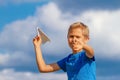 Boy throwing paper plane against blue sky Royalty Free Stock Photo