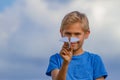 Boy throwing paper plane on summer day Royalty Free Stock Photo