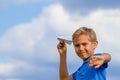 Boy throwing paper plane on summer day Royalty Free Stock Photo