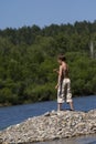 Boy throwing stone in lake Royalty Free Stock Photo