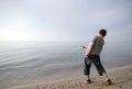 Boy Throwing Stone In Water Royalty Free Stock Photo