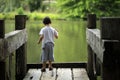 Boy throwing stones to the lake Royalty Free Stock Photo