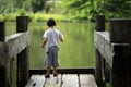 Boy throwing stones to the lake