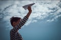 Boy throwing white paper plane. Royalty Free Stock Photo