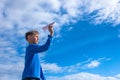 Boy throwing white paper plane. Royalty Free Stock Photo