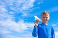 Boy throwing white paper plane. Royalty Free Stock Photo