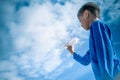 Boy throwing white paper plane. Royalty Free Stock Photo