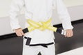 Boy tieing the yellow belt Royalty Free Stock Photo