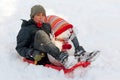 Boy with toboggan and snowman