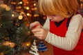 Boy toddler decorate the christmas tree close up