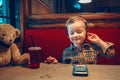 Boy toddler playing with digital gadget phone with earphones Royalty Free Stock Photo