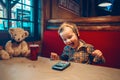 Boy toddler playing with digital gadget phone with earphones Royalty Free Stock Photo