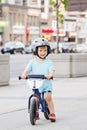 Boy toddler riding a balance bike bicycle in helmet on the road Royalty Free Stock Photo