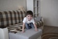 Boy toddler sad on couch in real room home