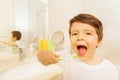 Boy with toothbrush and mouth wide opened