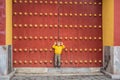 Boy tourist on the background of the large Chinese gates. Travel with children in China concept