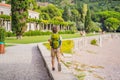 Boy tourist walking together in Montenegro. Panoramic summer landscape of the beautiful green Royal park Milocer on the Royalty Free Stock Photo