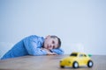 Boy and toy car on a table Royalty Free Stock Photo