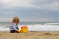 Boy with toy trowel bucket