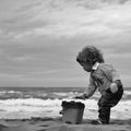 Boy with toy trowel bucket