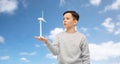 boy with toy wind turbine over blue sky and clouds Royalty Free Stock Photo