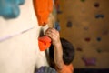 The boy trains on a climbing wall. Royalty Free Stock Photo