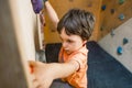 The boy trains on a climbing wall. Royalty Free Stock Photo