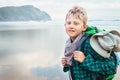 Boy traveler with backpack on ocean beach at the erly morning Royalty Free Stock Photo
