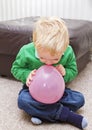 Boy trying to blow balloon Royalty Free Stock Photo
