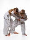 The boy is trying to make a cut for a girl in judo class