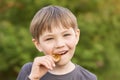 Boy trying to taste the Bitcoin in the summer in the Park. Royalty Free Stock Photo