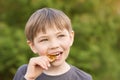 Boy trying to taste the Bitcoin in the summer in the Park. Royalty Free Stock Photo