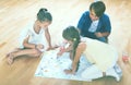 Boy and two girls playing at board game indoors Royalty Free Stock Photo