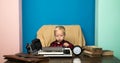 Boy typewrite special report on vintage typewriter. Little photojournalist work on written report at office desk Royalty Free Stock Photo