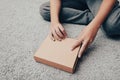 A boy unboxing unpacking a parcell, delivery, online shopping purchase concept