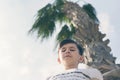 Boy under coconut palm tree and sky Royalty Free Stock Photo