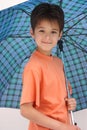 A boy under an open umbrella