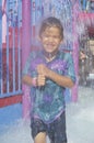 A boy under a water fountain Royalty Free Stock Photo