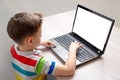 Boy use a laptop computer mockup. Isolated screen for app, game or web site design presentation Royalty Free Stock Photo