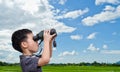 Boy using binoculars in field Royalty Free Stock Photo