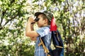 Boy using binoculars in the forest Royalty Free Stock Photo