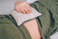 Boy using cherry stone thermal pillows, cherry pit filled pillow - natural heat or cool pack. Alternative medicine and