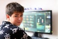 Boy using computer at home, playing game Royalty Free Stock Photo