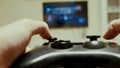 Boy using a controller to play a video-game Royalty Free Stock Photo