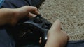 Boy using a controller to play a video-game Royalty Free Stock Photo