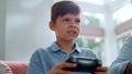 Boy using gamepad for computer game. Male gamer pushing buttons on joystick