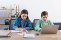 boy using laptop and girl writing Royalty Free Stock Photo