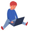 Boy using laptop. Kid sitting on floor with computer Royalty Free Stock Photo