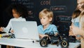 Boy using laptop programing engineering code and writing program. Erudition. Royalty Free Stock Photo